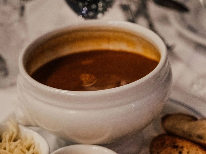 a white plate topped with soup and bread